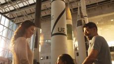 A family views a rocket in the museum exhibit hall
