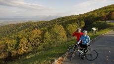 Bikers along the Blue Ridge Parkway stopping on the edge of the road to look at the rolling Blue Ridge Mountains in Virginia, USA