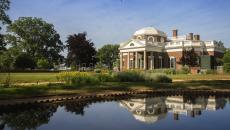 A view over a quiet, reflective pond of Monticello in Charlottesville, Virginia, USA.