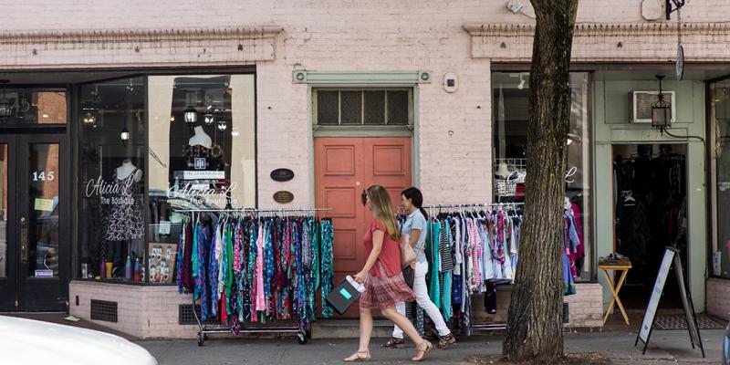 People strolling past shops in historical buildings in the city centre of Frederick, Maryland, USA