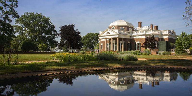 A view over a quiet, reflective pond of Monticello in Charlottesville, Virginia, USA.