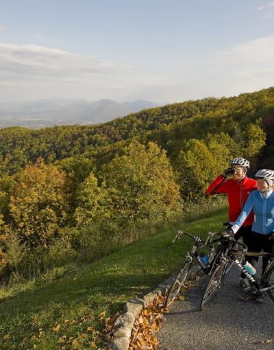 Bikers along the Blue Ridge Parkway stopping on the edge of the road to look at the rolling Blue Ridge Mountains in Virginia, USA