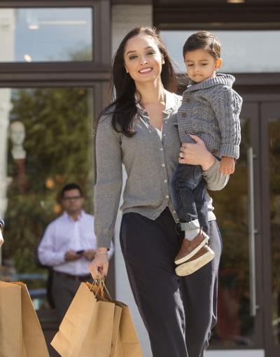 A family with small children walks with shopping bags in the Georgetown neighbourhood of Washington, DC.